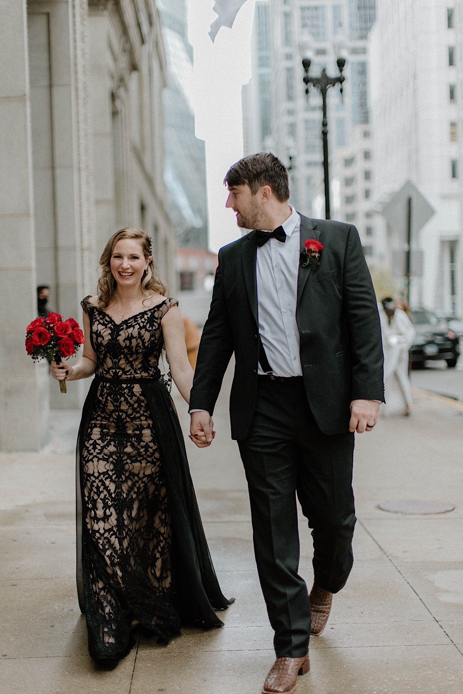 Couple holds hands outside Chicago City Hall after elopement