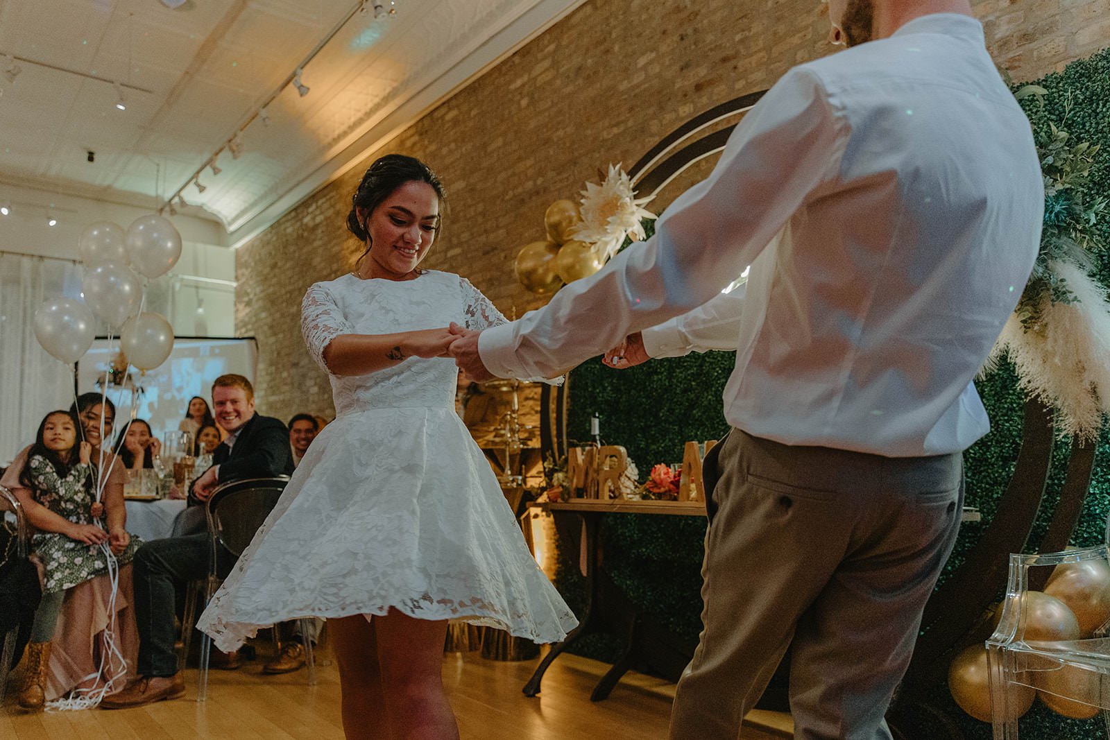 Newly wed couple shares their first dance in front of their friends and family