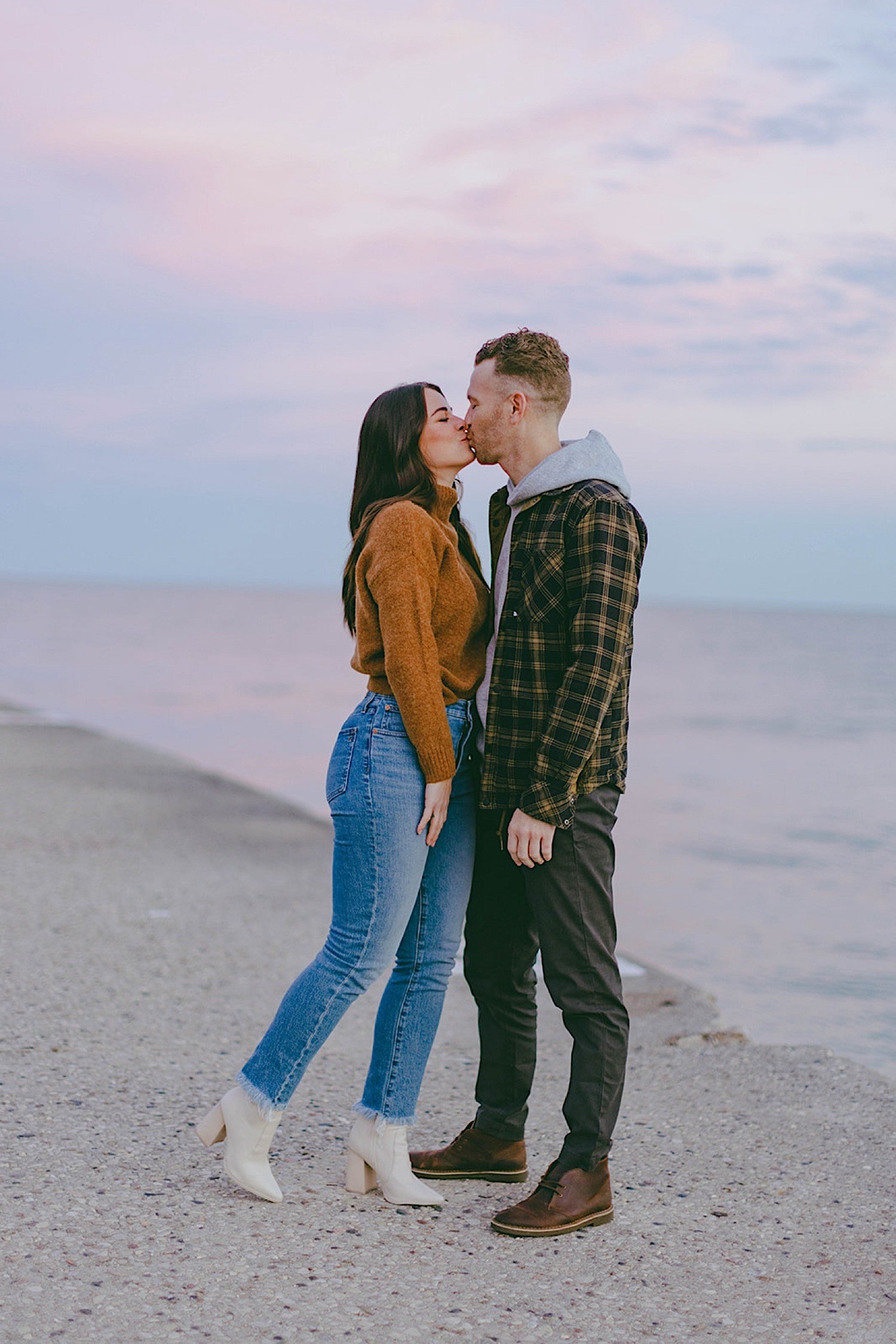 Couple kiss in front of Lake Michigan during blue hour