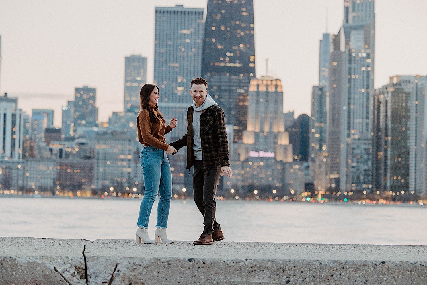Couple laughing together with Chicago's skyline in the background
