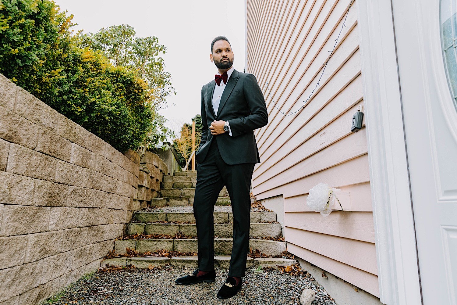 Portrait of a groom in front of an outdoor staircase before his wedding