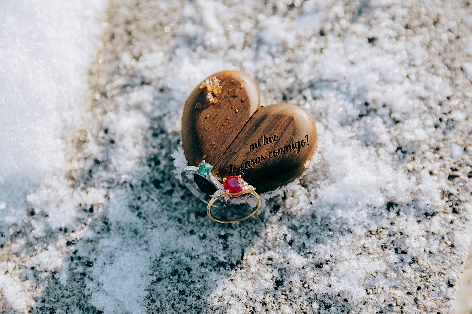 Ring box and 2 engagement rings in the snow