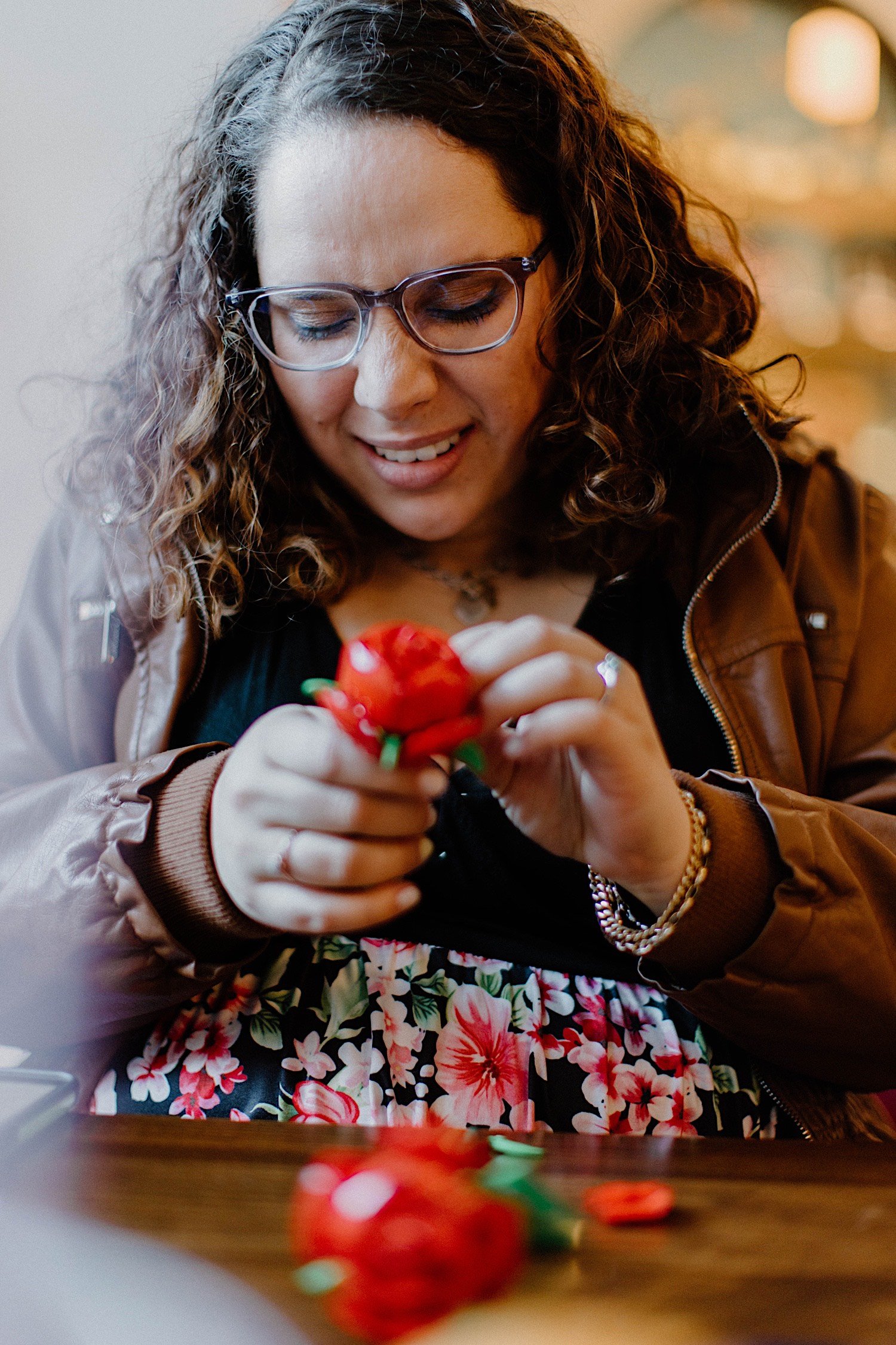 Woman putting a Lego rose together in a restaurant