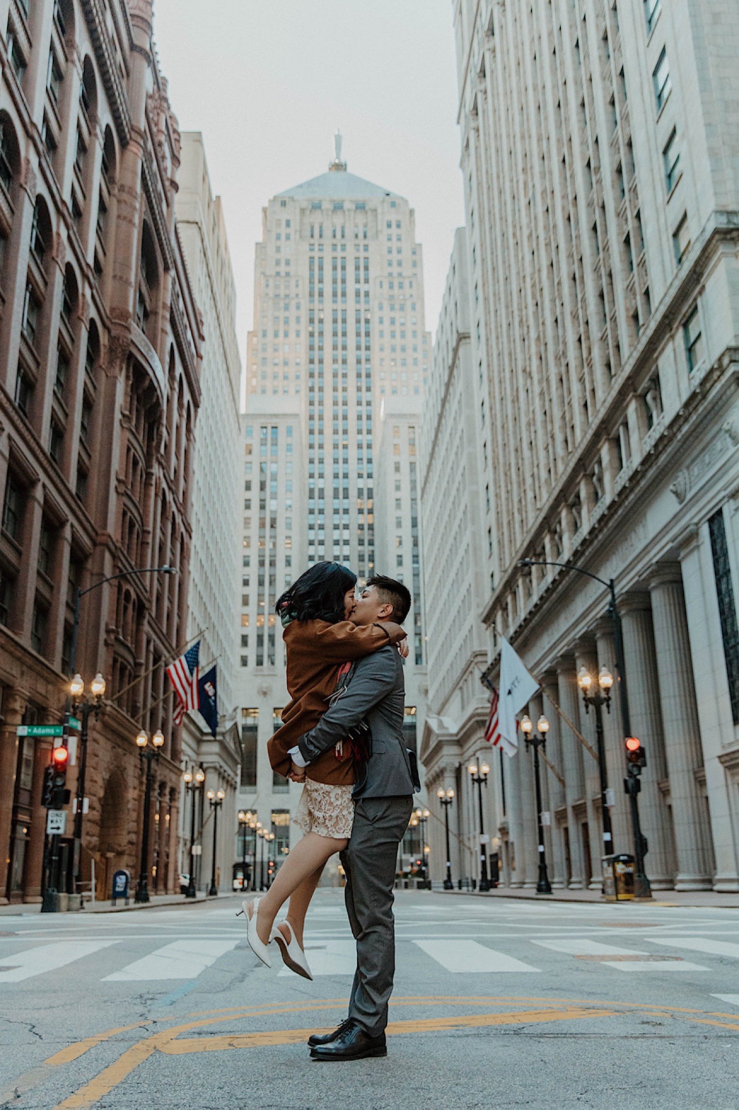 Man lifts and kisses his fiancée in the street in downtown Chicago