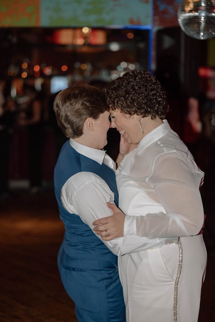 A couple embrace and smile as they dance together while celebrating their elopement
